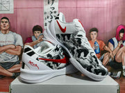 Pair of white Nike basketball-style sneakers with black and gray patterned uppers, red accents, and a shoebox.