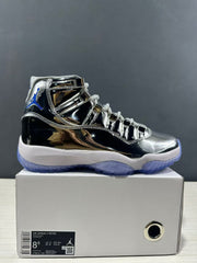 Side view of a reflective silver and black Air Jordan 11 sneaker on its box; the box label shows size 8.5, EU 42, CM 26.5, and style code CT8012 730.