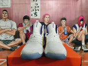 Front view of white Nike Hyperdunk high-top shoes with yellow and purple accents.