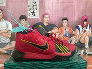 Side view showing the red upper, black-and-yellow swoosh detailing, textured panels, and black outsole.