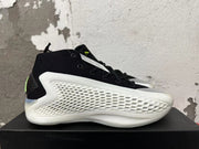 Side view showing the black upper, white textured side panel, and sculpted sole.