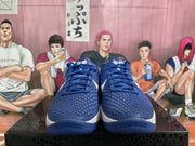 Front view of blue Nike Kobe basketball shoes showing textured uppers, blue laces, and white accents.