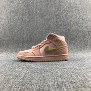 Full side profile of the pink Jordan sneaker with olive-green Swoosh and stitched panels.