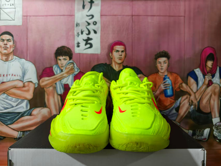 Front view of neon green Nike GT Cut basketball shoes with red accents