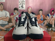 Front view of white and navy Nike sneakers