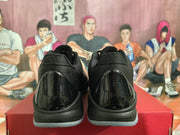 Rear view showing glossy black heel panels and tonal black collars.