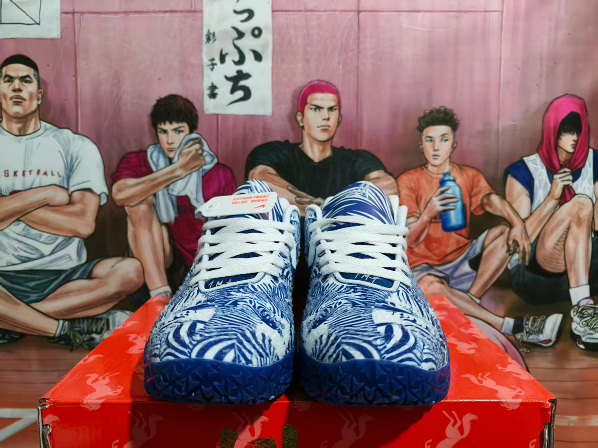 Front view of navy and white Nike basketball sneakers with patterned uppers and white laces on a red shoebox.