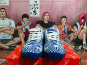 Front view of navy and white Nike basketball sneakers with patterned uppers and white laces on a red shoebox.