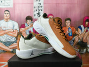 Pair of brown and white basketball shoes shown from the side and at an angle.