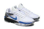 Pair of white basketball shoes with blue side logos and black spotted detailing