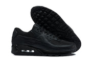 Black Nike Air Max 90 sneaker beside an outsole view showing the patterned tread.