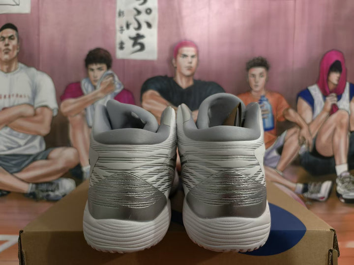 Rear view of white and silver-gray ASICS basketball shoes