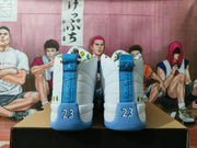 Rear view of white and blue high-top Jordan sneakers with number 23 heel details.