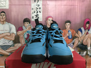 Pair of blue and white Nike sneakers shown from the front with black laces and toe sections.
