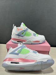 Close angled view highlighting the white upper, lime green mesh, pink midsole, and translucent outsole edge.