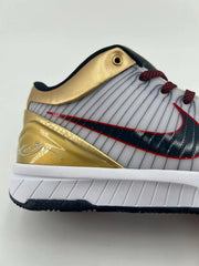 Close-up of the gold heel overlay, striped upper, and side logo.