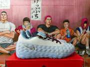 Side profile of a white basketball sneaker with silver Nike branding, dark laces, and a sculpted outsole.