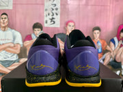 Rear view showing the purple heels, yellow signature-style graphics, and black midsoles with yellow detailing.