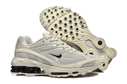 Nike Shox Ride 2 sneakers shown from the side and underside, highlighting the patterned outsole.