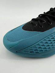 Angled view of blue toe panel, black laces, and molded sidewall