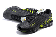 Pair of black and volt Nike Air Max Plus sneakers shown from an angled top view.