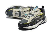Pair of black and grey chunky sneakers shown from above and at an angle, highlighting the laces and layered panels.