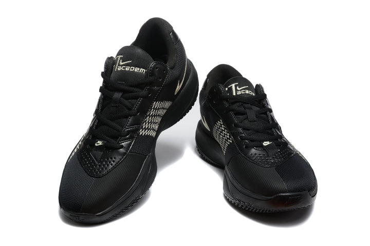Pair of black Nike basketball sneakers shown from a front three-quarter angle with light-colored Swoosh accents.