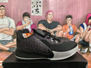 Side view of a black and purple patterned sneaker with black laces and a contrasting outsole.