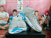 Angled view of the gray and blue sneaker pair showing blue outsole accents, the side panel design, and a visible heel air window.