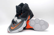 Nike high-top basketball shoe shown with the patterned outsole facing upward and the side profile visible.