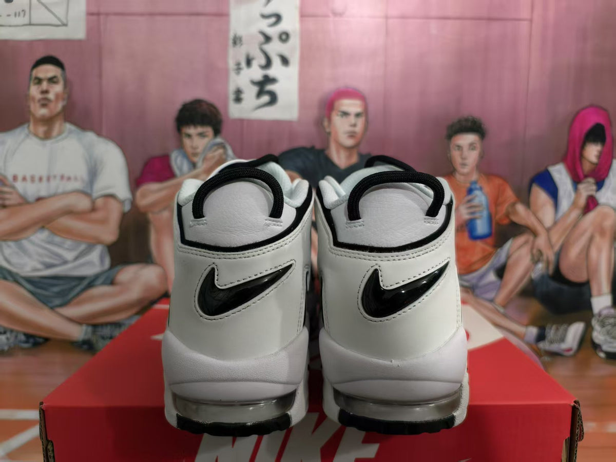 Rear view of white and black Nike sneakers showing black heel trim, heel logos and visible sole windows.