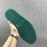 Underside view showing the green rubber outsole tread pattern.