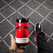 Rear view showing the glossy red heel panel, black collar and white midsole.
