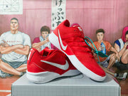 Pair of red Nike basketball sneakers with white Swoosh branding displayed on a box.