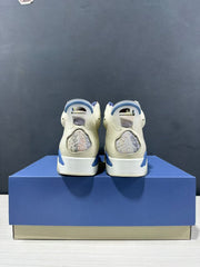 Rear view showing the heel panels, translucent pull tabs, and blue outsole accents.