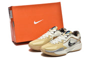 The Nike sneakers displayed beside an orange Nike shoebox, showing the khaki and white colorway and patterned outsole.