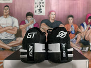 Rear view of black and white Nike basketball sneakers showing GT heel branding, contrasting heel panels, and textured outsoles.