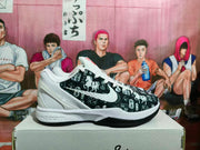 Side view of one Nike basketball sneaker showing the patterned upper, white Swoosh, layered white midsole, and Kobe marking.