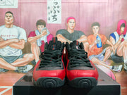 Front view of black and red high-top sneakers with black laces, padded collars, and visible AIR branding.