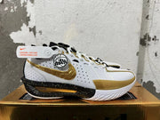 Side view showing the gold Swoosh and speckled black midsole