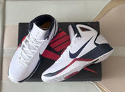 Pair of white high-top Nike basketball shoes displayed on a black box
