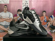Angled view of the Nike basketball sneakers displayed one over the other, showing the side Swoosh, laces, and layered midsole.