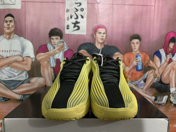Pair of yellow and black Nike basketball sneakers viewed from above, showing black laces and layered side detailing.