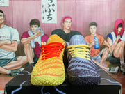 Front view of mismatched orange/yellow and blue/navy basketball shoes.