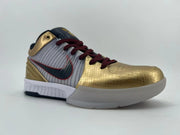 Opposite low side angle of the sneaker with gold and white panels and dark side logo.