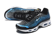Angled view of the black, blue, and white Nike Air Max Plus VII sneakers.