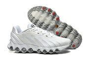Side and outsole views of white Nike Air Max DN sneakers with gray tread and red accents.