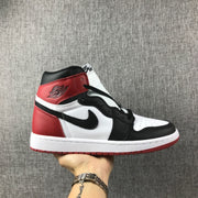 Side view of a black, white, and red Air Jordan 1 high-top sneaker