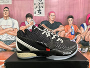 Side view of a black Nike Kobe sneaker showing the swoosh, Off-White™ marking, and contrasting sole.