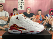 Side profile of a white Jordan high-top sneaker with red accents, perforated panels, and a visible heel Air unit.